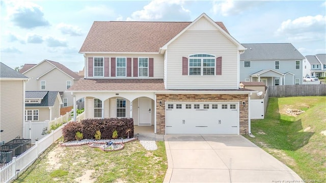 2912 Seafarer Dr, Fayetteville, NC 28306 - traditional-style house with driveway, roof with shingles, a garage, covered porch, and a residential view