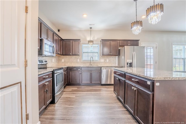 2912 Seafarer Dr, Fayetteville, NC 28306 - kitchen with stainless steel appliances, a sink, dark brown cabinetry, and plenty of natural light