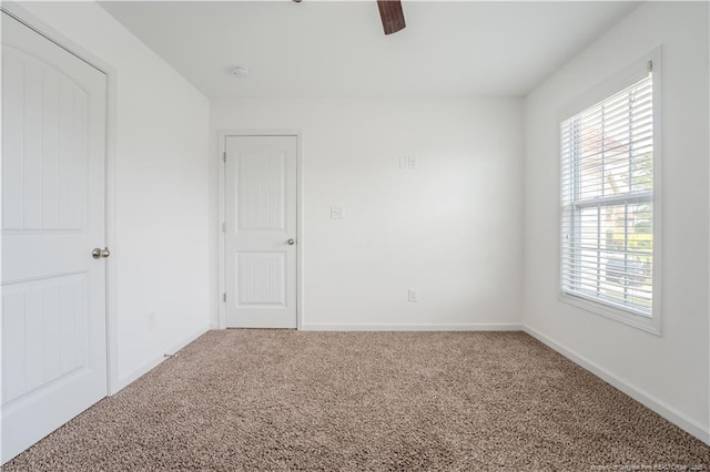 2912 Seafarer Dr, Fayetteville, NC 28306 - unfurnished bedroom featuring carpet flooring, multiple windows, baseboards, and a ceiling fan
