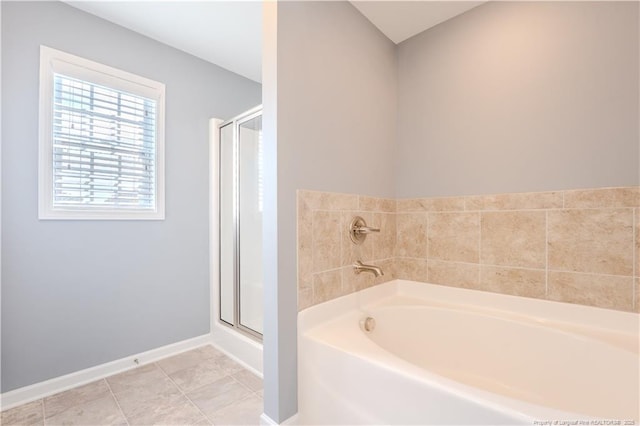 2912 Seafarer Dr, Fayetteville, NC 28306 - bathroom with a bath, a shower stall, and baseboards