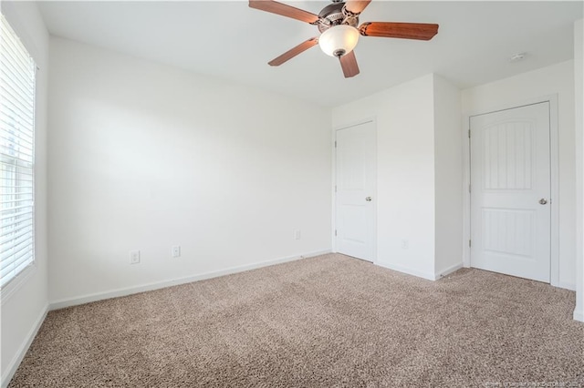 2912 Seafarer Dr, Fayetteville, NC 28306 - unfurnished bedroom with carpet, multiple windows, baseboards, and a ceiling fan