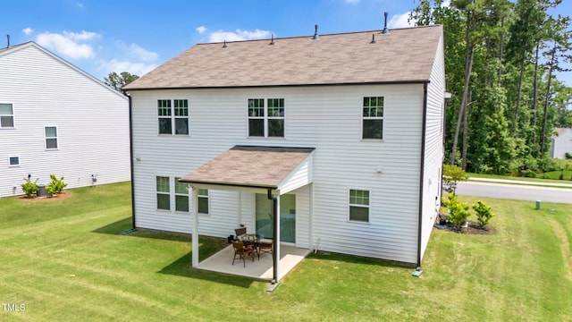 31 Pascoli Ct, Clayton, NC 27527 - back of property with roof with shingles, a lawn, and a patio