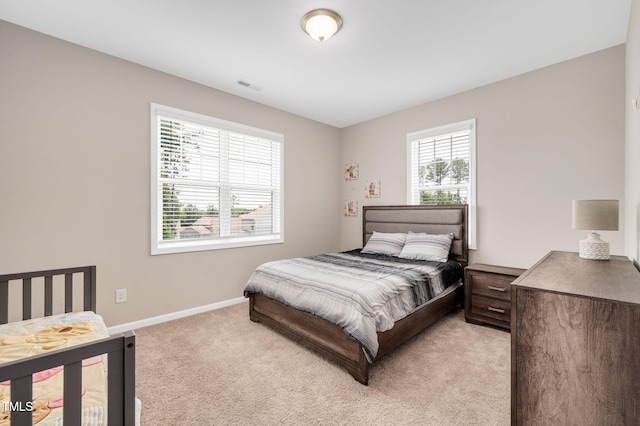 31 Pascoli Ct, Clayton, NC 27527 - bedroom with multiple windows, light carpet, and baseboards