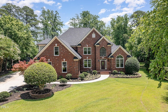 6553 Vintage Ridge Ln, Fuquay Varina, NC 27526 - view of front of property featuring brick siding, a front yard, and roof with shingles