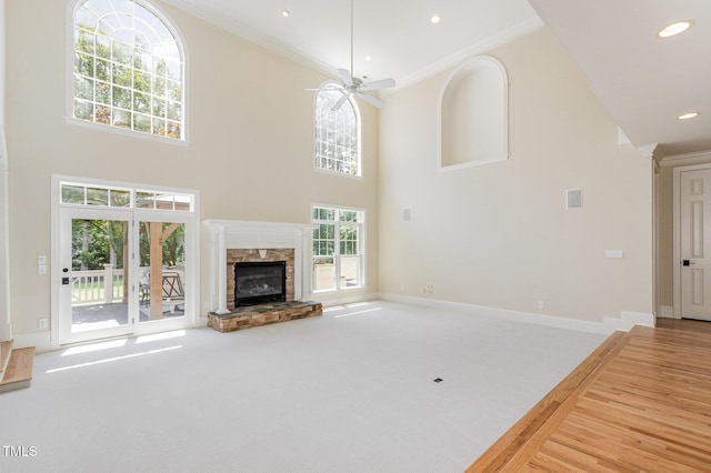 6553 Vintage Ridge Ln, Fuquay Varina, NC 27526 - unfurnished living room with ornamental molding, a fireplace, a ceiling fan, carpet flooring, and a high ceiling