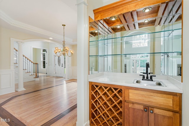 6553 Vintage Ridge Ln, Fuquay Varina, NC 27526 - bar area featuring a sink, a decorative wall, decorative columns, a wainscoted wall, and stairway