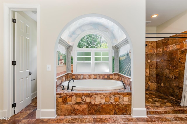 6553 Vintage Ridge Ln, Fuquay Varina, NC 27526 - bathroom featuring a garden tub, tiled shower, and stone finish floors