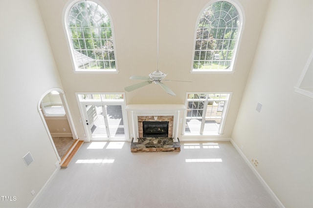 6553 Vintage Ridge Ln, Fuquay Varina, NC 27526 - unfurnished living room with a towering ceiling, healthy amount of natural light, and a ceiling fan