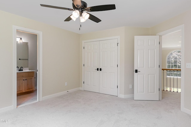 6553 Vintage Ridge Ln, Fuquay Varina, NC 27526 - unfurnished bedroom featuring light carpet, a closet, a sink, and baseboards