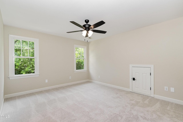 6553 Vintage Ridge Ln, Fuquay Varina, NC 27526 - empty room with plenty of natural light, a ceiling fan, light colored carpet, and baseboards