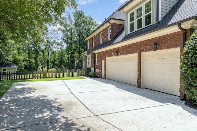 6553 Vintage Ridge Ln, Fuquay Varina, NC 27526 - view of property exterior with concrete driveway, a garage, brick siding, and roof with shingles