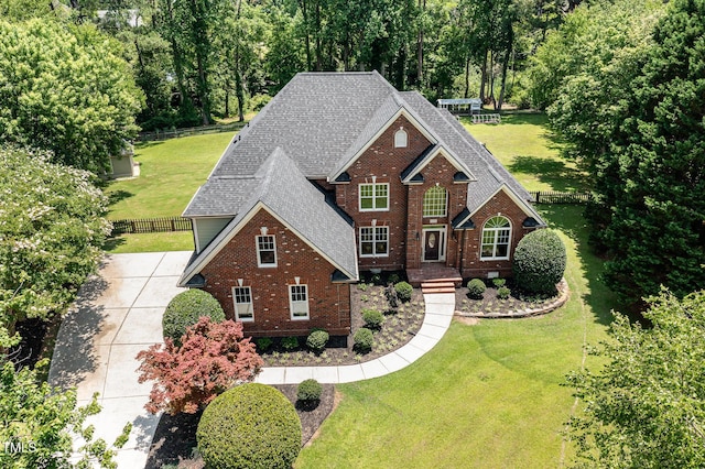 6553 Vintage Ridge Ln, Fuquay Varina, NC 27526 - traditional-style house featuring a shingled roof, brick siding, and concrete driveway