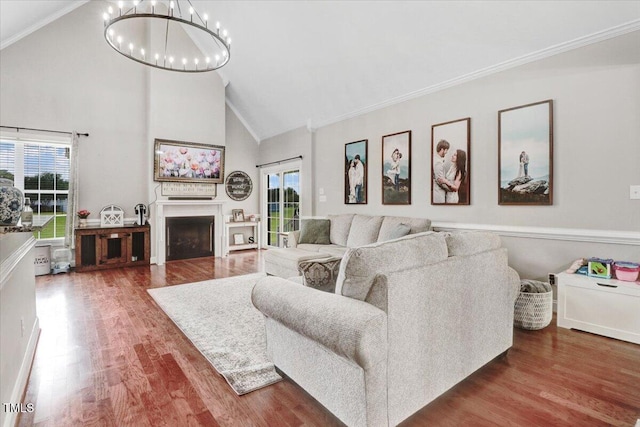 103 Kayla Marie Ln, Goldsboro, NC 27530 - living area featuring high vaulted ceiling, healthy amount of natural light, a chandelier, wood finished floors, and ornamental molding