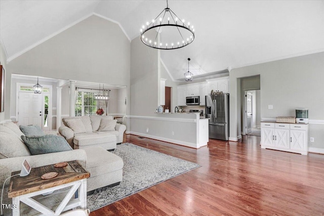 103 Kayla Marie Ln, Goldsboro, NC 27530 - living room with a chandelier, high vaulted ceiling, dark wood-style floors, baseboards, and ornamental molding