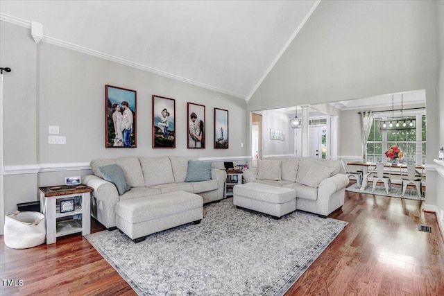 103 Kayla Marie Ln, Goldsboro, NC 27530 - living room with crown molding, a chandelier, high vaulted ceiling, and wood finished floors