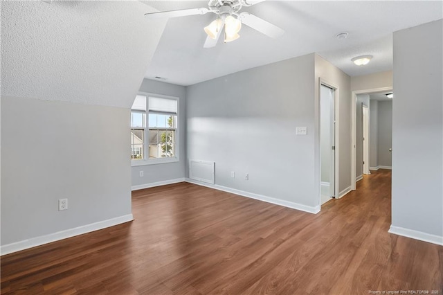 4420 Battle Forest Rd, Hope Mills, NC 28348 - unfurnished room with a ceiling fan, baseboards, wood finished floors, and a textured ceiling