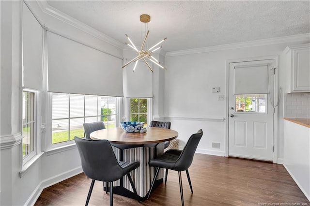 1502 E 11th St, Lumberton, NC 28358 - dining room with a chandelier, wood finished floors, crown molding, baseboards, and a textured ceiling