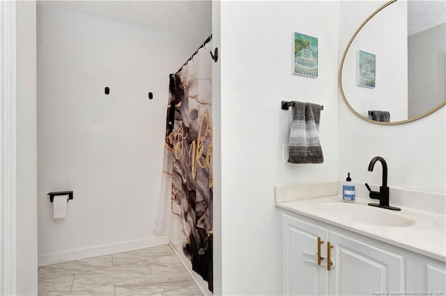 1502 E 11th St, Lumberton, NC 28358 - full bathroom with marble look tiles, vanity, baseboards, and curtained shower