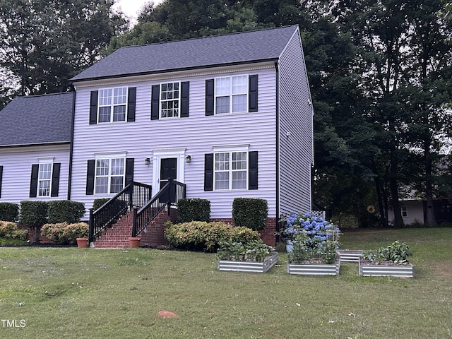 120 Feezor Ct, Clayton, NC 27527 - colonial house featuring a garden, a front lawn, and a shingled roof