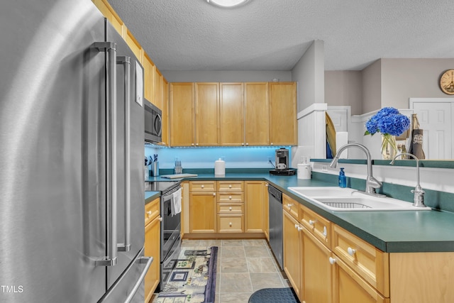 120 Feezor Ct, Clayton, NC 27527 - kitchen with appliances with stainless steel finishes, a textured ceiling, dark countertops, a peninsula, and light brown cabinets