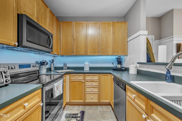 120 Feezor Ct, Clayton, NC 27527 - kitchen featuring appliances with stainless steel finishes, a textured ceiling, and dark countertops