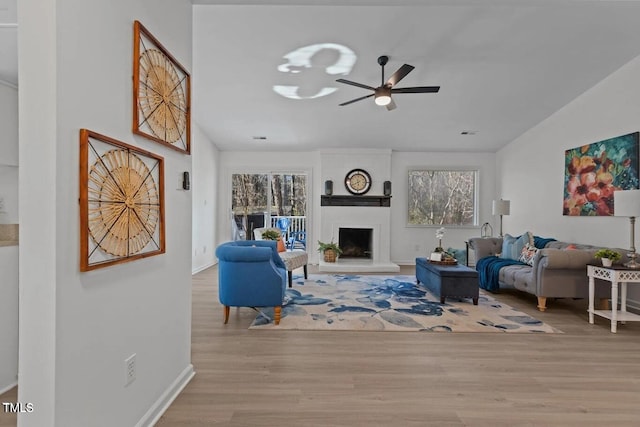 1536 Maybrook Dr, Raleigh, NC 27610 - living room with wood finished floors, ceiling fan, a fireplace, lofted ceiling, and baseboards