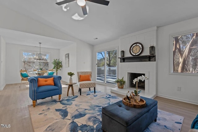 1536 Maybrook Dr, Raleigh, NC 27610 - living area with wood finished floors, healthy amount of natural light, a ceiling fan, a chandelier, and vaulted ceiling