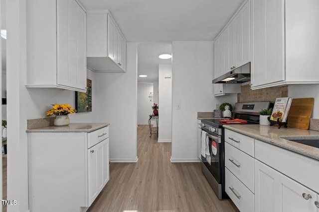 1536 Maybrook Dr, Raleigh, NC 27610 - kitchen featuring under cabinet range hood, stainless steel electric range oven, light wood-style floors, white cabinets, and light countertops
