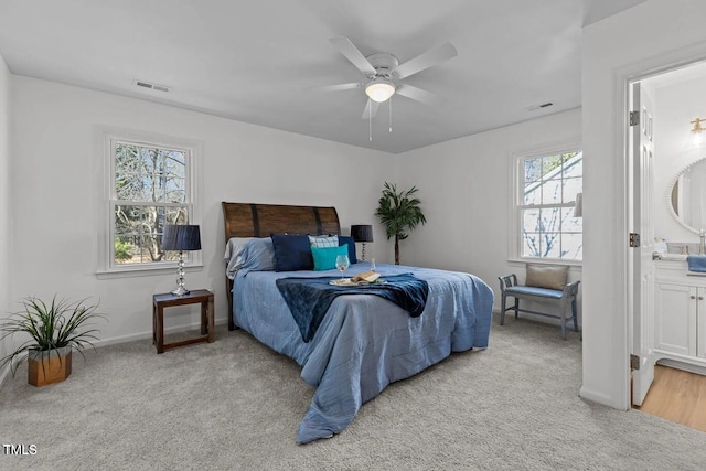 1536 Maybrook Dr, Raleigh, NC 27610 - bedroom featuring light carpet, multiple windows, ensuite bath, and baseboards