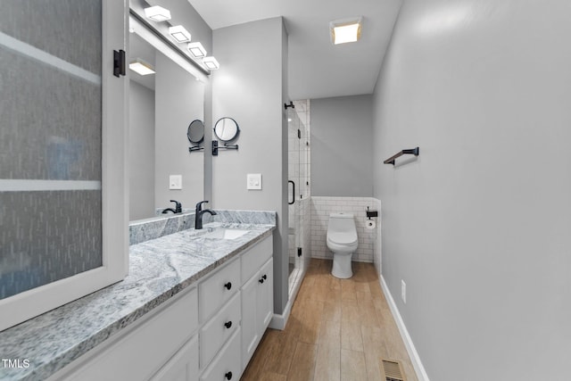 1383 Deercroft Ct, Graham, NC 27253 - full bath with toilet, a stall shower, vanity, tile walls, and wood finished floors