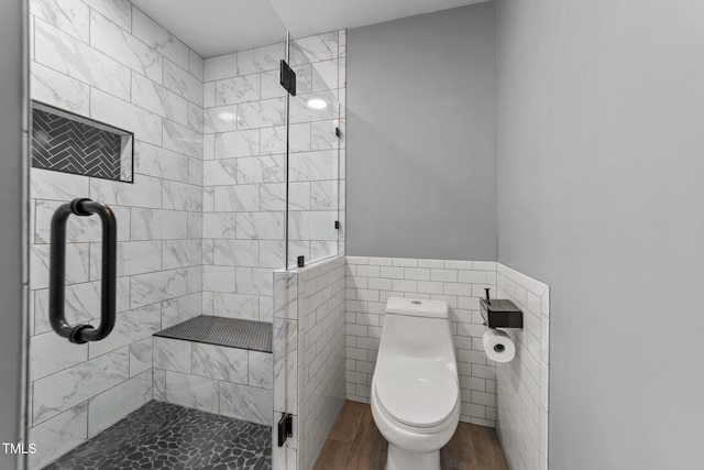 1383 Deercroft Ct, Graham, NC 27253 - bathroom featuring tile walls, a shower stall, wood finished floors, toilet, and a wainscoted wall