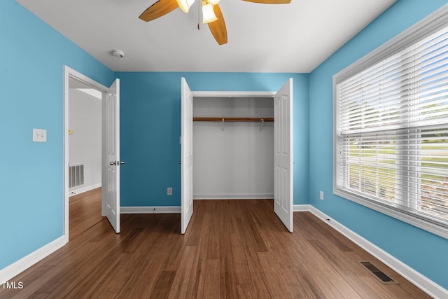 1383 Deercroft Ct, Graham, NC 27253 - unfurnished bedroom with a closet, multiple windows, wood finished floors, and baseboards