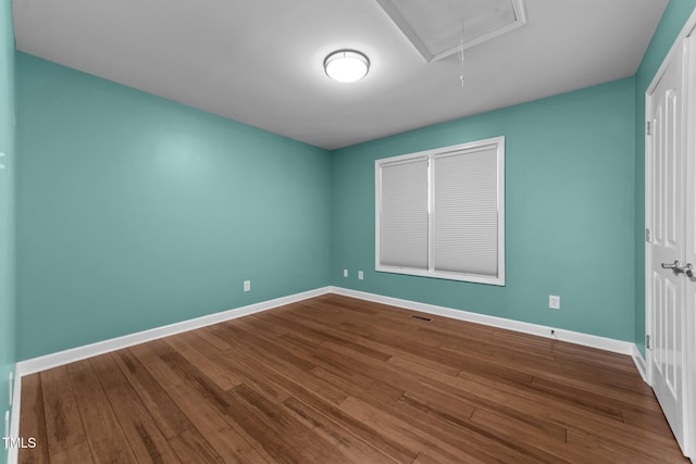 1383 Deercroft Ct, Graham, NC 27253 - unfurnished bedroom featuring attic access, baseboards, and dark wood-style floors