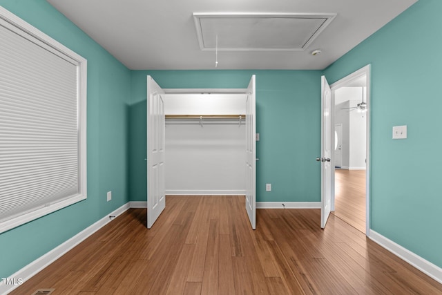 1383 Deercroft Ct, Graham, NC 27253 - unfurnished bedroom featuring attic access, wood finished floors, a closet, and baseboards
