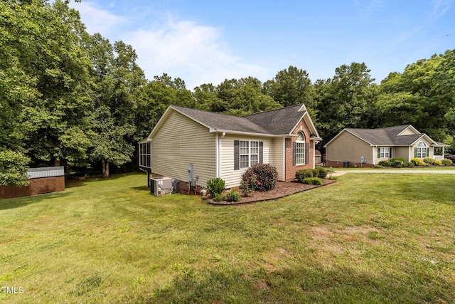 1383 Deercroft Ct, Graham, NC 27253 - view of home's exterior featuring a yard and central AC unit