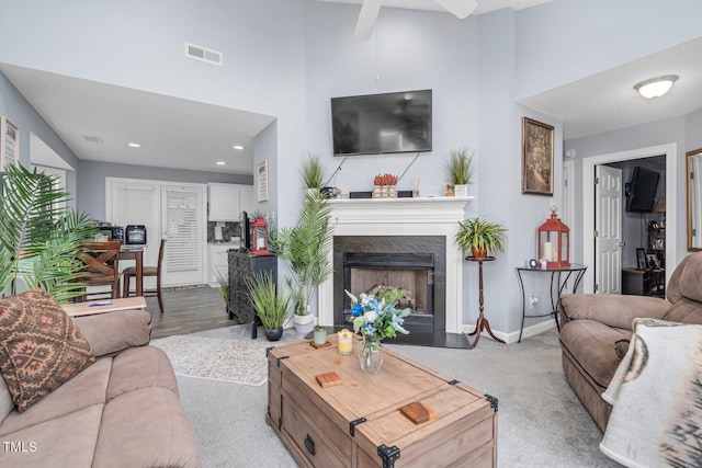 1516 Greys Mill Rd, Rocky Mount, NC 27804 - living room featuring a towering ceiling, a premium fireplace, a ceiling fan, recessed lighting, and carpet floors