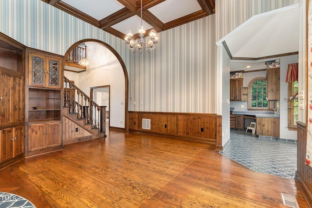 610 Walnut Creek Dr, Goldsboro, NC 27534 - unfurnished living room with wood finished floors, a chandelier, coffered ceiling, a wainscoted wall, and beam ceiling