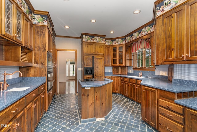 610 Walnut Creek Dr, Goldsboro, NC 27534 - kitchen featuring open shelves, a sink, a center island, brown cabinetry, and crown molding