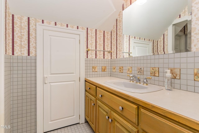 610 Walnut Creek Dr, Goldsboro, NC 27534 - bathroom featuring wallpapered walls, vanity, tile walls, tile patterned flooring, and tasteful backsplash