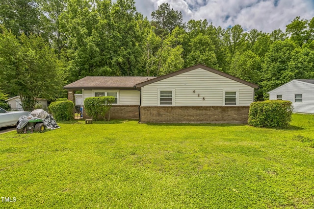 428 Walton St, Durham, NC 27703 - view of front facade with brick siding and a front lawn