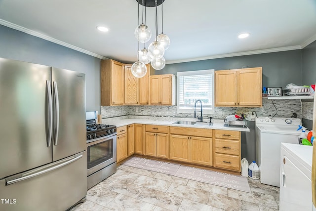 428 Walton St, Durham, NC 27703 - kitchen with appliances with stainless steel finishes, a sink, separate washer and dryer, crown molding, and light countertops