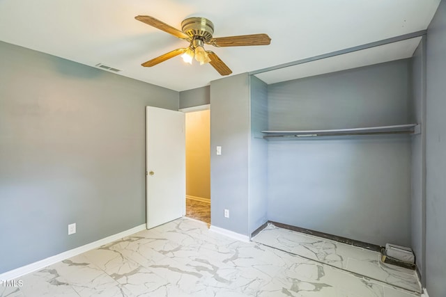428 Walton St, Durham, NC 27703 - unfurnished bedroom with marble finish floors, baseboards, and ceiling fan