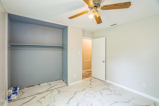 428 Walton St, Durham, NC 27703 - unfurnished bedroom featuring marble finish flooring, ceiling fan, baseboards, and a closet