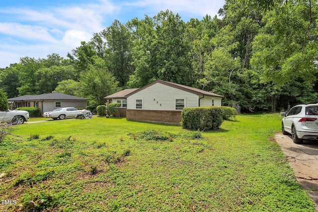 428 Walton St, Durham, NC 27703 - view of side of property featuring brick siding and a yard