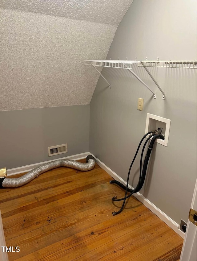 300 Christmas Rd, Warrenton, NC 27589 - washroom with hookup for a washing machine, hardwood / wood-style floors, and a textured ceiling