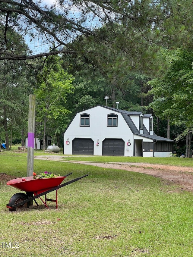 300 Christmas Rd, Warrenton, NC 27589 - view of home's exterior with dirt driveway, a yard, a detached garage, and view of scattered trees