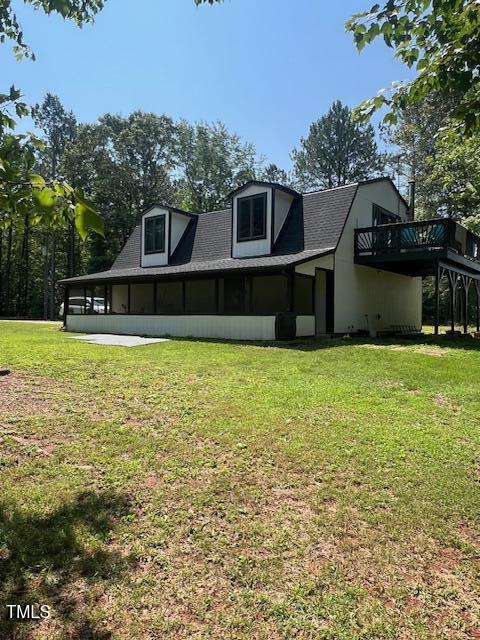 300 Christmas Rd, Warrenton, NC 27589 - rear view of property featuring a yard, a deck, and a sunroom