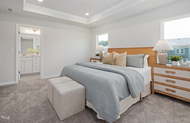 1525 Tamarisk Ln, Durham, NC 27703 - carpeted bedroom featuring crown molding, a raised ceiling, ensuite bath, recessed lighting, and baseboards