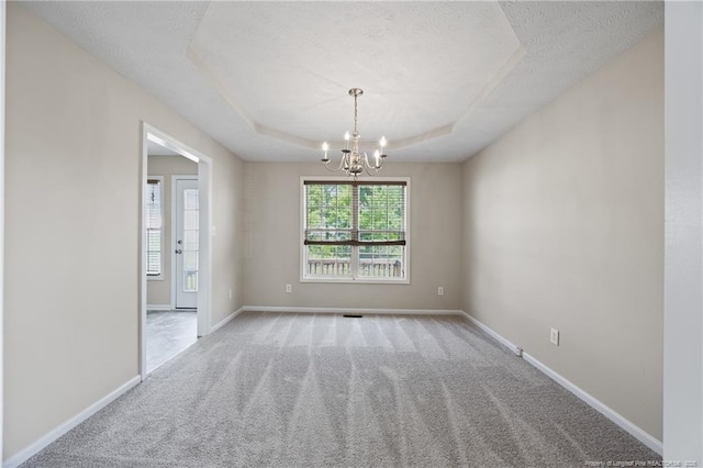 5511 Shady Lawn Dr, Hope Mills, NC 28348 - unfurnished room featuring a raised ceiling, carpet, a chandelier, a textured ceiling, and baseboards