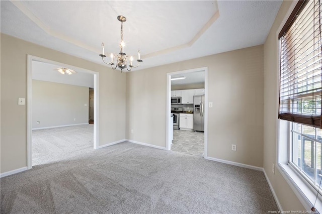 5511 Shady Lawn Dr, Hope Mills, NC 28348 - empty room featuring a chandelier, light carpet, baseboards, and a raised ceiling
